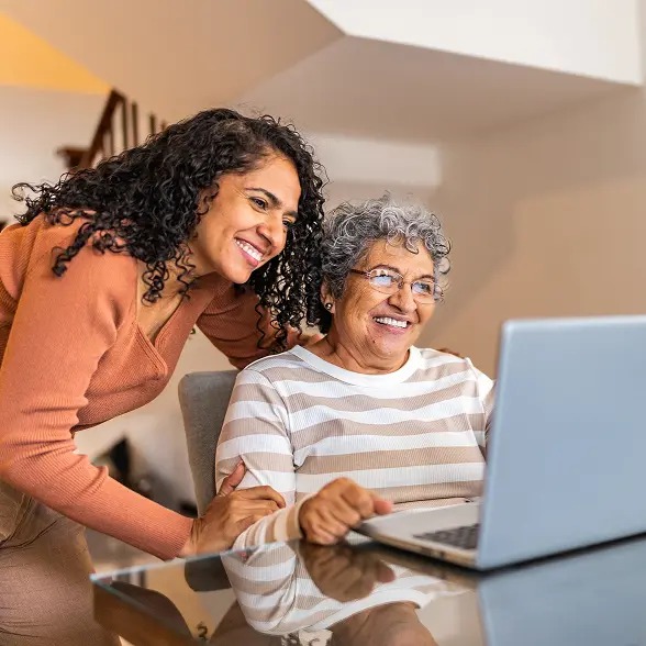 Inset_LegacyPlanning_Choose-converted mother and daughter looking at laptop screen and smiling for some reason