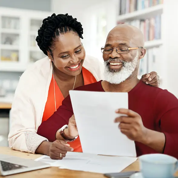 Inset_LegacyPlanning_Power-converted Older couple looking at a document presumably giving someone power of attorney and smiling for some reason