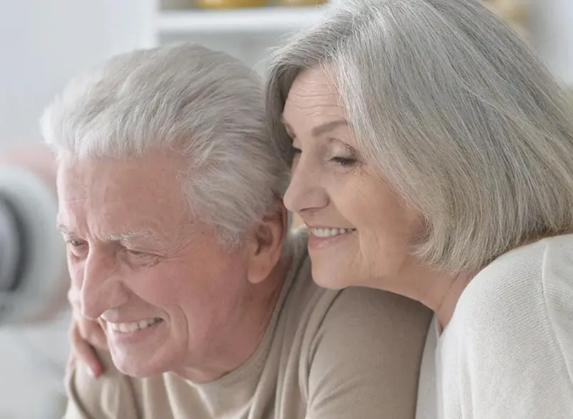 OurServices_SSS-converted Elderly couple hugging and smiling for some reason