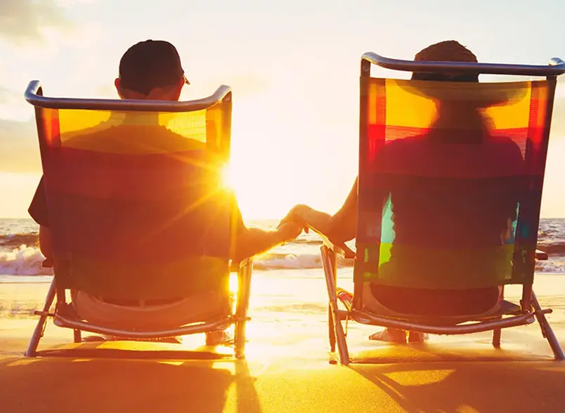 OurServices_TES-converted behind a couple in beach chairs at sunset